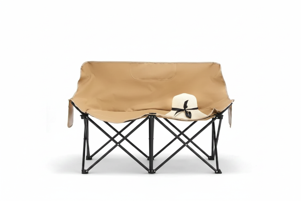 Tan khaki double camping loveseat chair with black steel frame, straw hat on seat, white background, no props