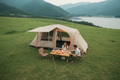 Aerial view of beige automatic family tent with awning extended, couple camping on green hillside with table and chairs